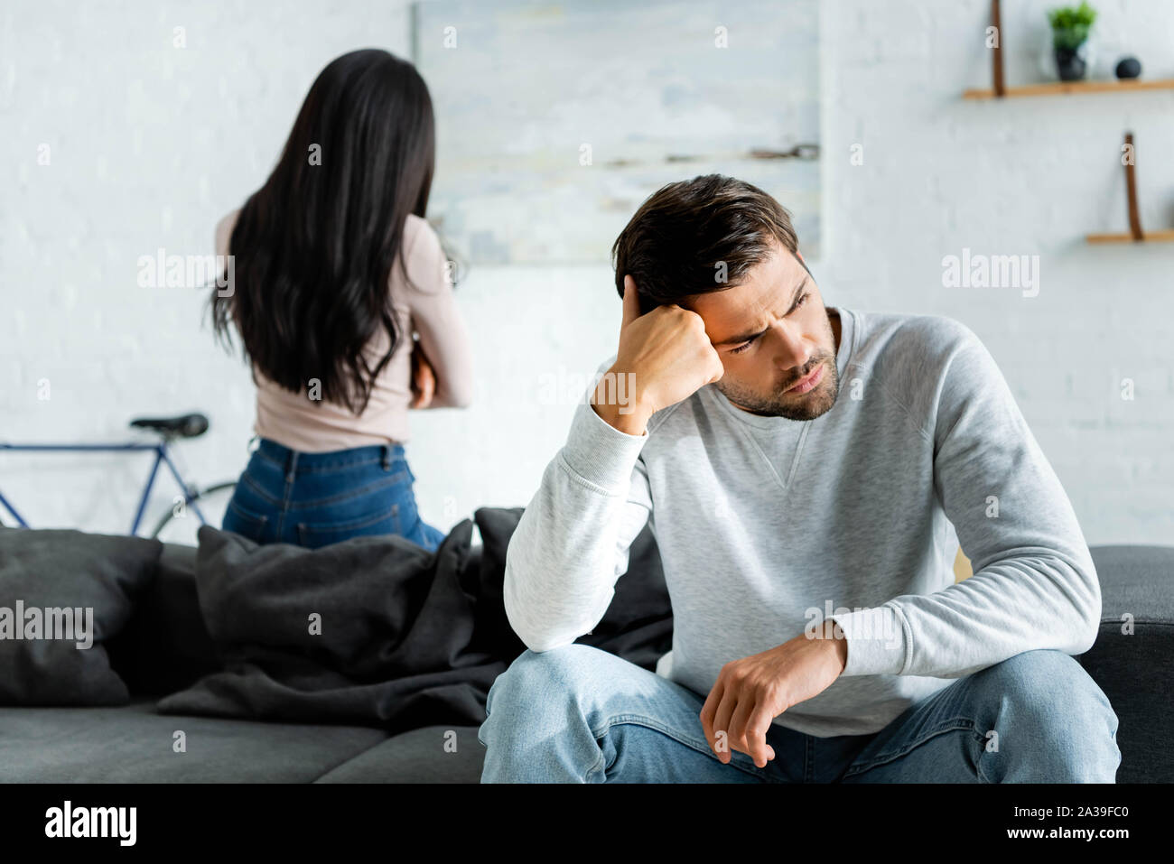 selective focus of sad and handsome man and african american woman ...