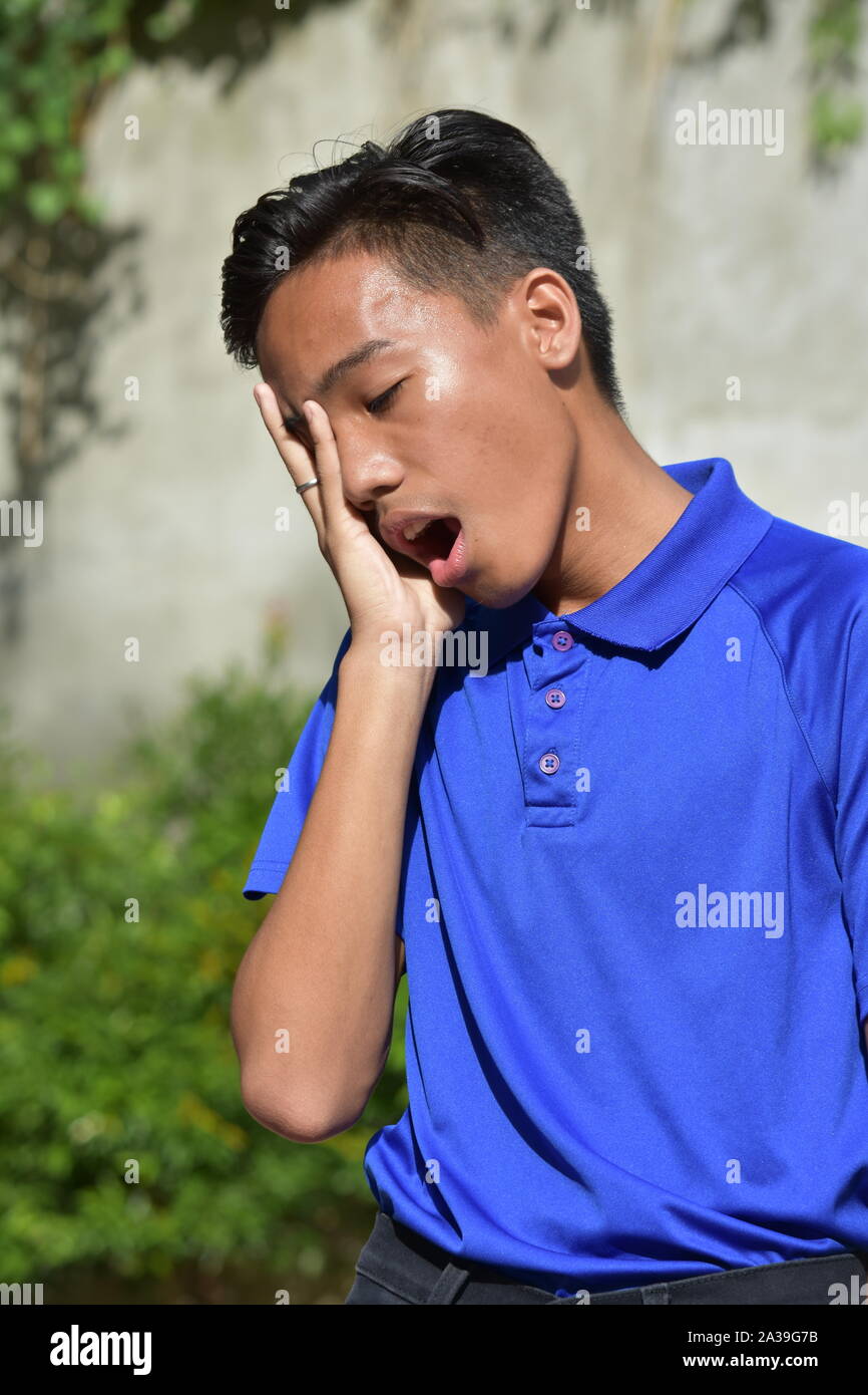 An A Yawning Filipino Boy Stock Photo
