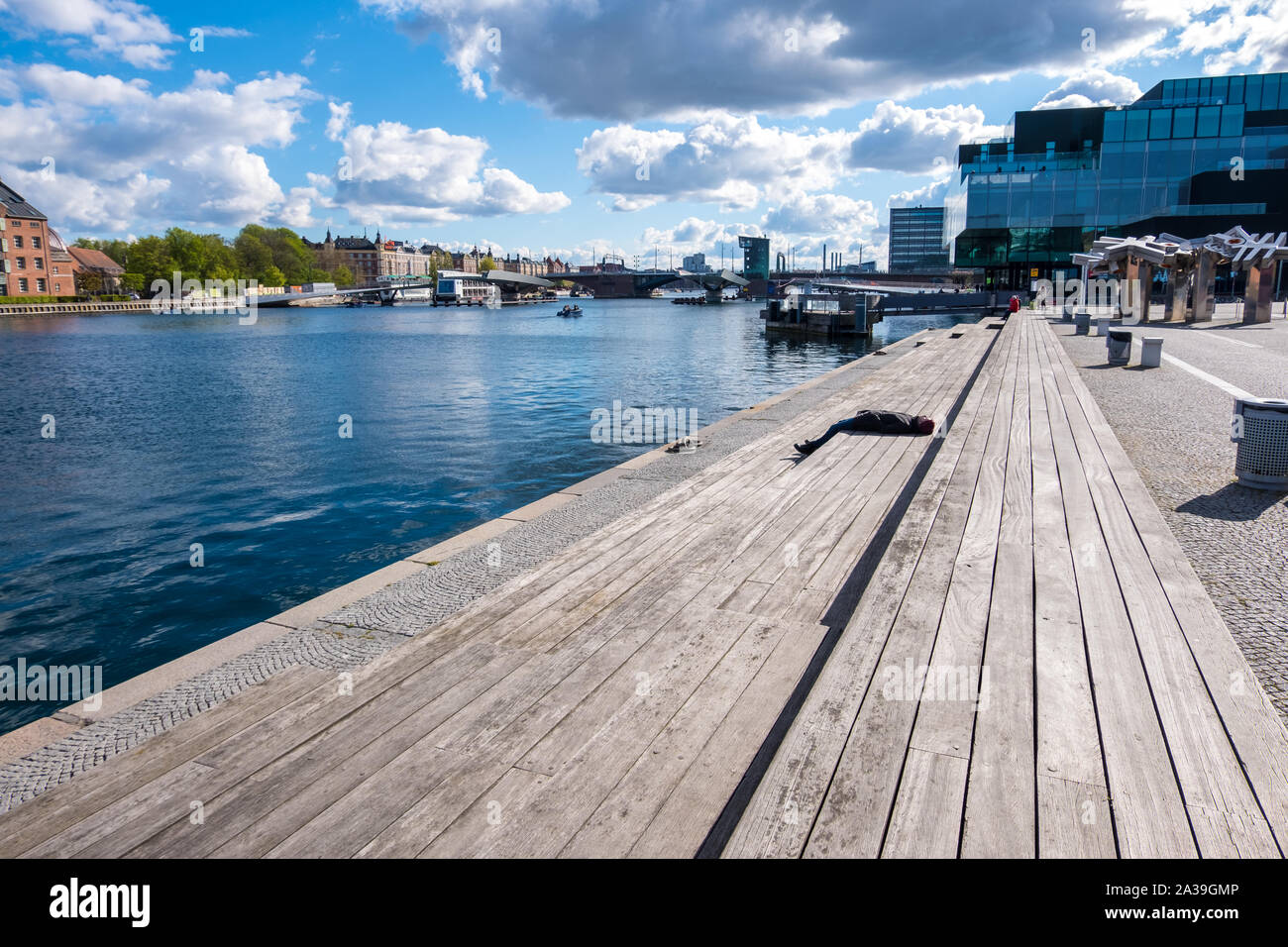 Copenhagen, Denmark - May 04, 2019: People relax on one of the waterfronts near the BLOX - Danish Architecture Center in Copenhagen Stock Photo
