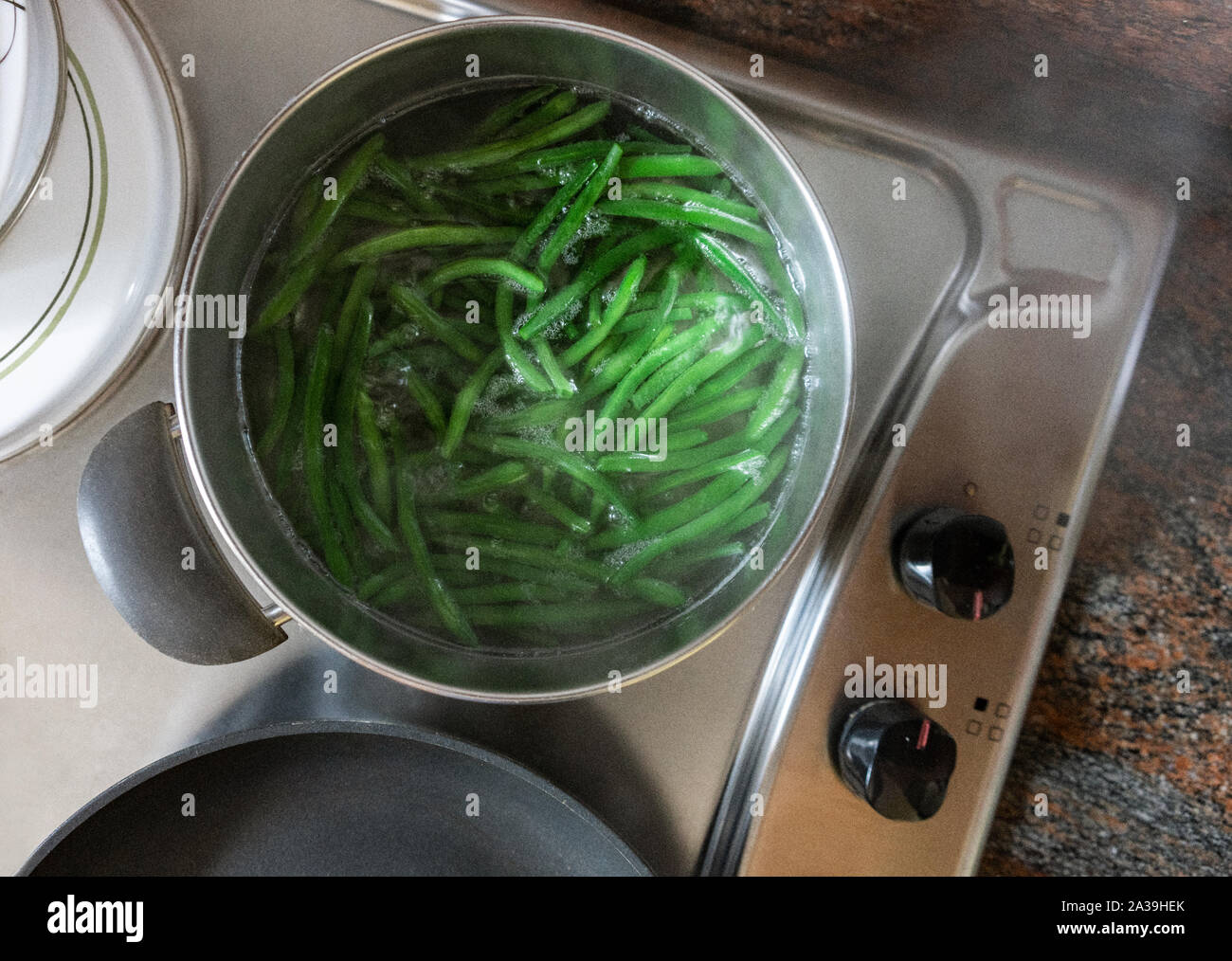 Green beans cooking in a pot Stock Photo