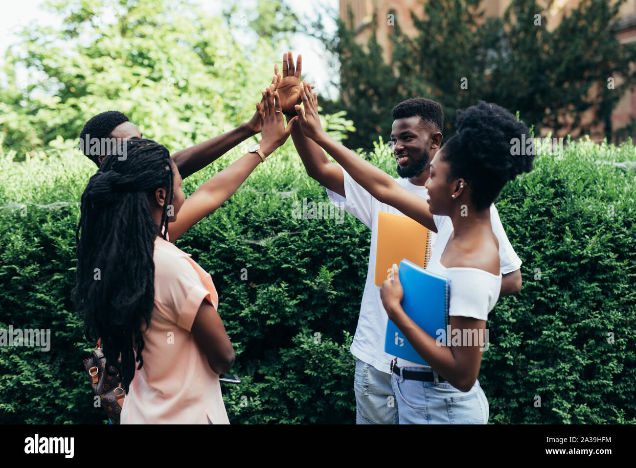 International group of young students giving high five celebrating ...
