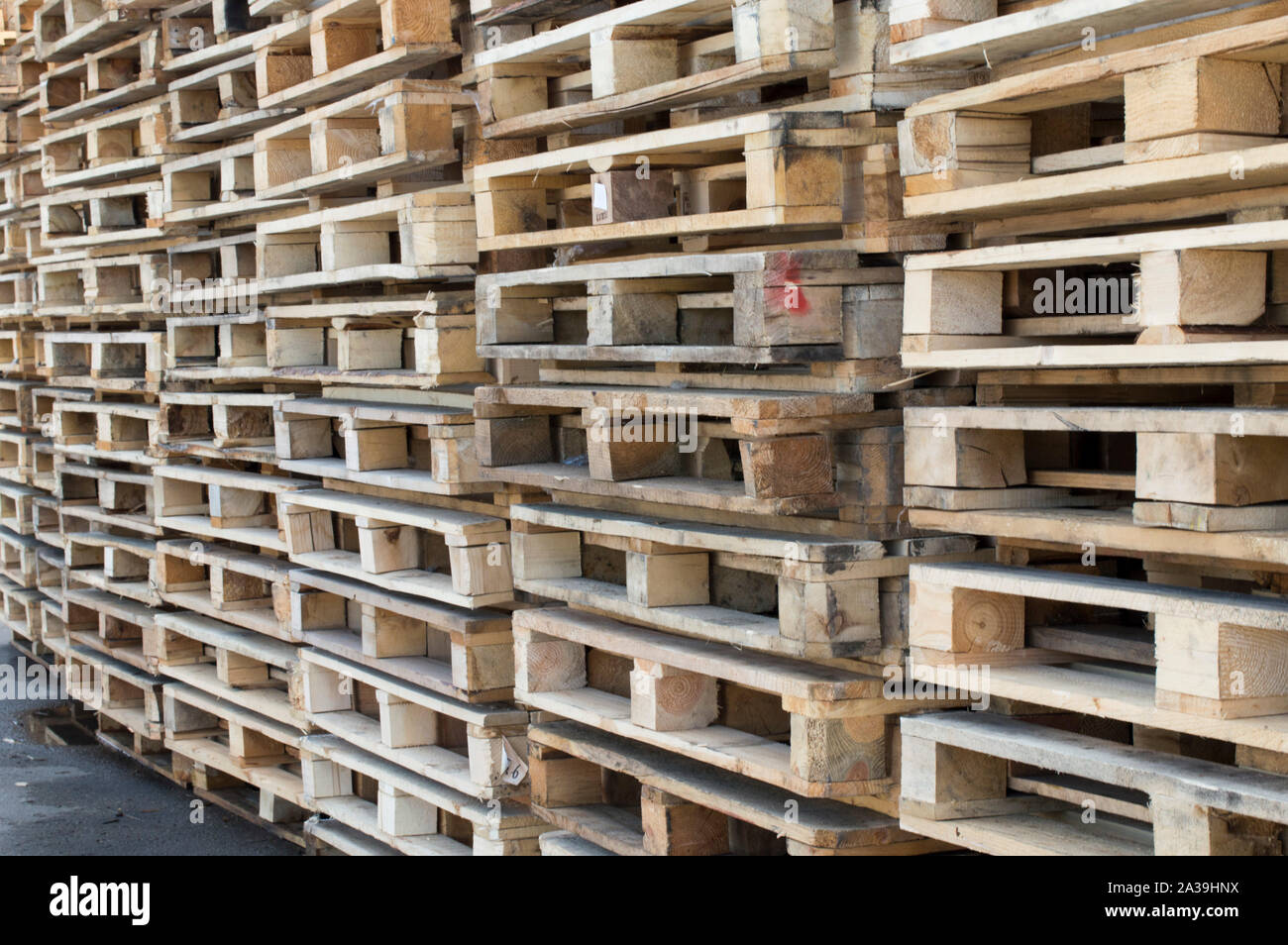 Racks and stacks of wooden Euro pallets, pallets are stored outdoors