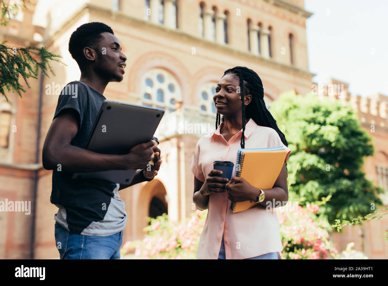 Male and female college students talking on campus Stock Photo - Alamy