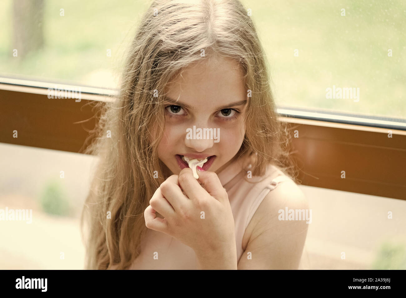 Chew gum to stay numb. Cute little girl chewing a gum. Adorable small