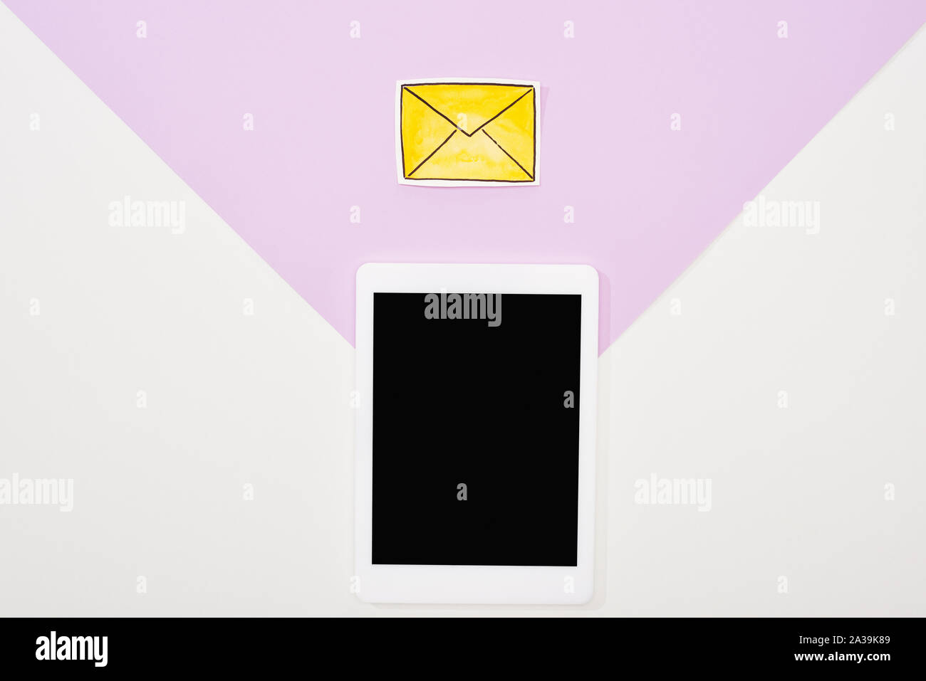 top view of digital tablet with blank screen and paper cut message icon ...