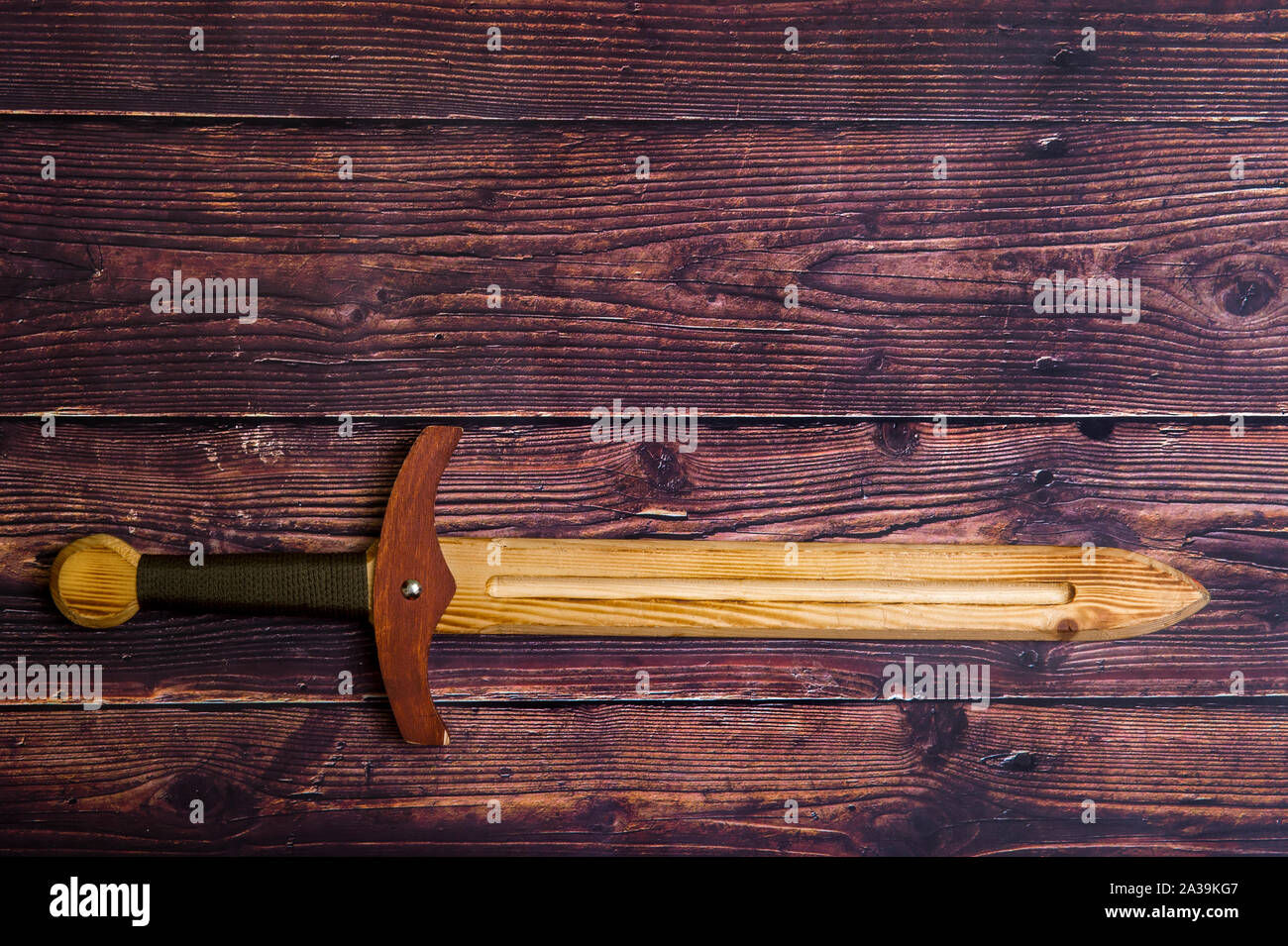 handmade wooden training toy sword on the table Stock Photo