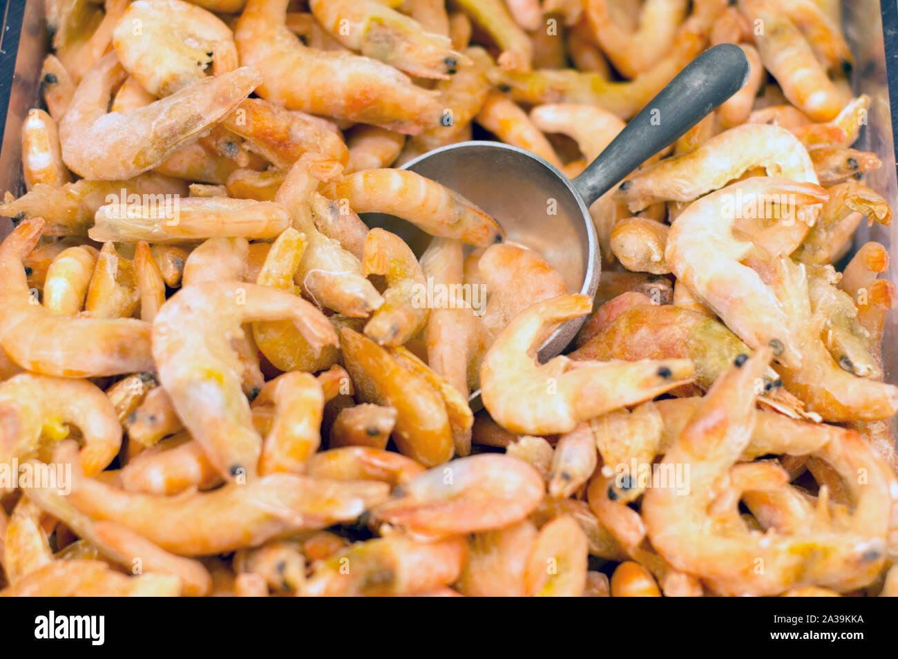 King prawns in ice, at the supermarket counter. Close-up. Stock Photo