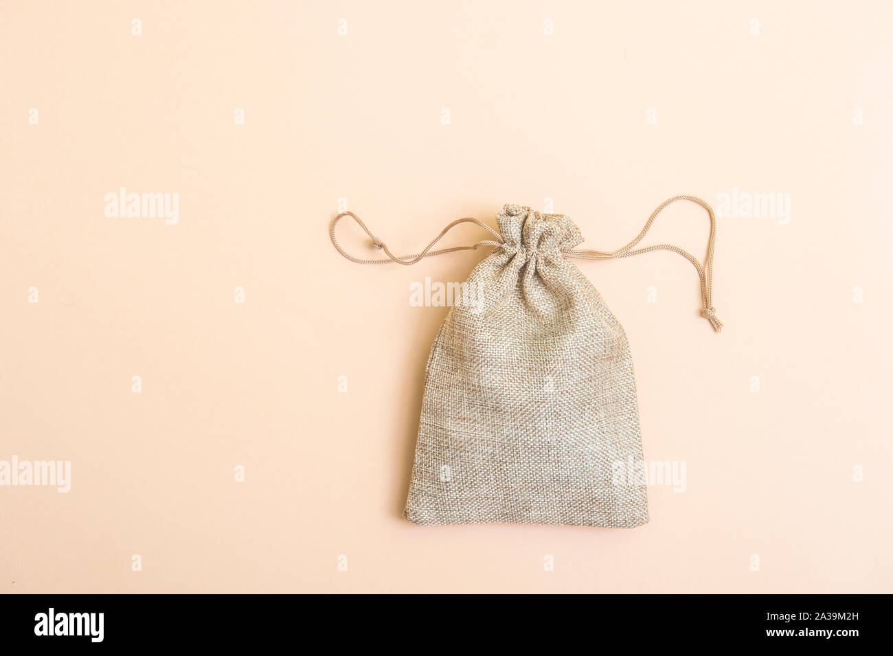 Money bag on light beige natural background Stock Photo