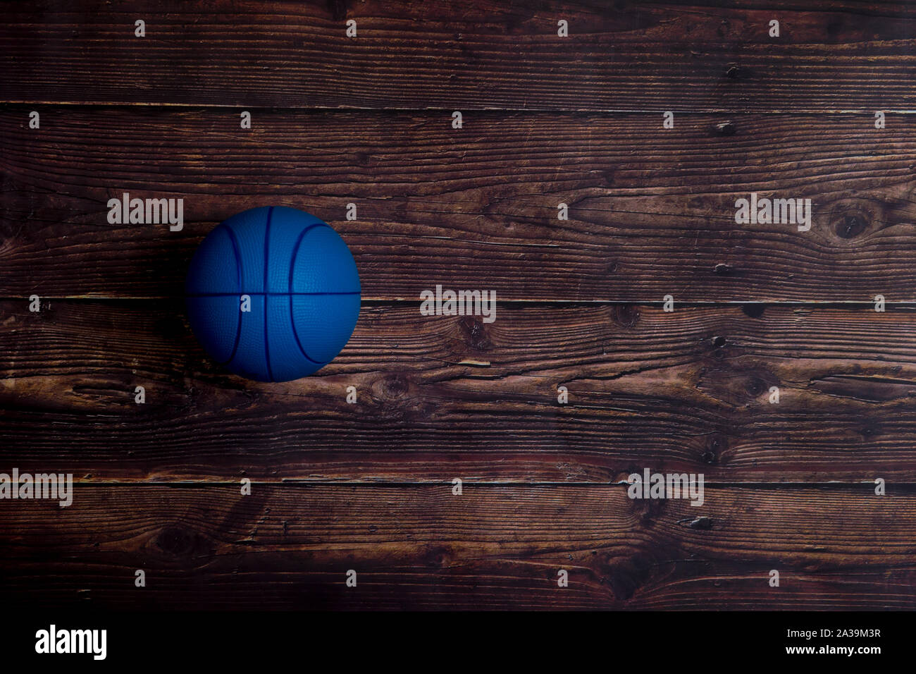 Blue Basketball On Old Hardwood Court Floor With Spot Lighting