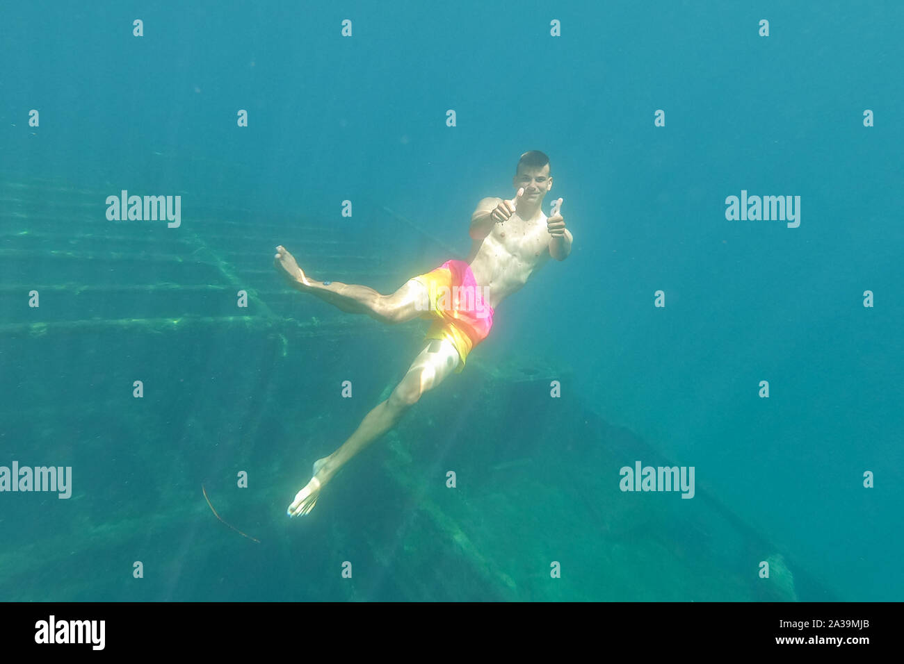 Diver looking at shipwreck under water, very old ship taken on the bottom of the sea, Zavratnica Croatia Stock Photo