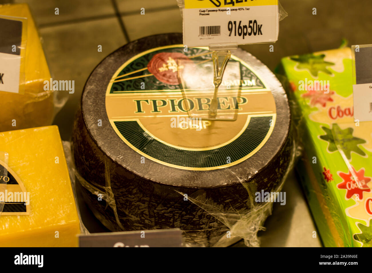 Types of cheese laid out for sale on the counter. Parmesan, Brewer