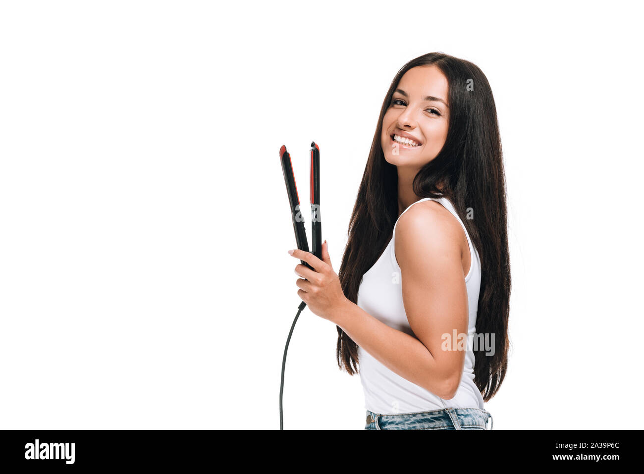 Woman holding hair straightener Cut Out Stock Images & Pictures - Alamy