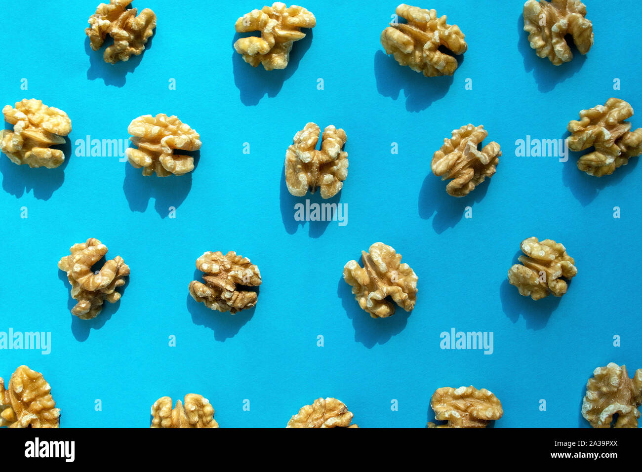 Walnuts pattern on blue background. Walnuts flat lay, top view. Stock Photo