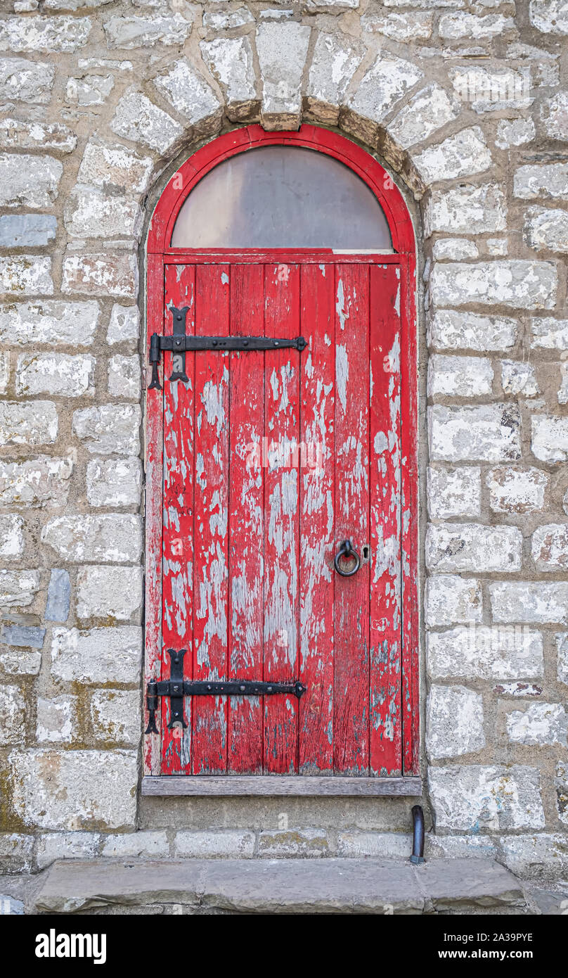 Well weathered old red door on the entrance to the Gibraltar Point