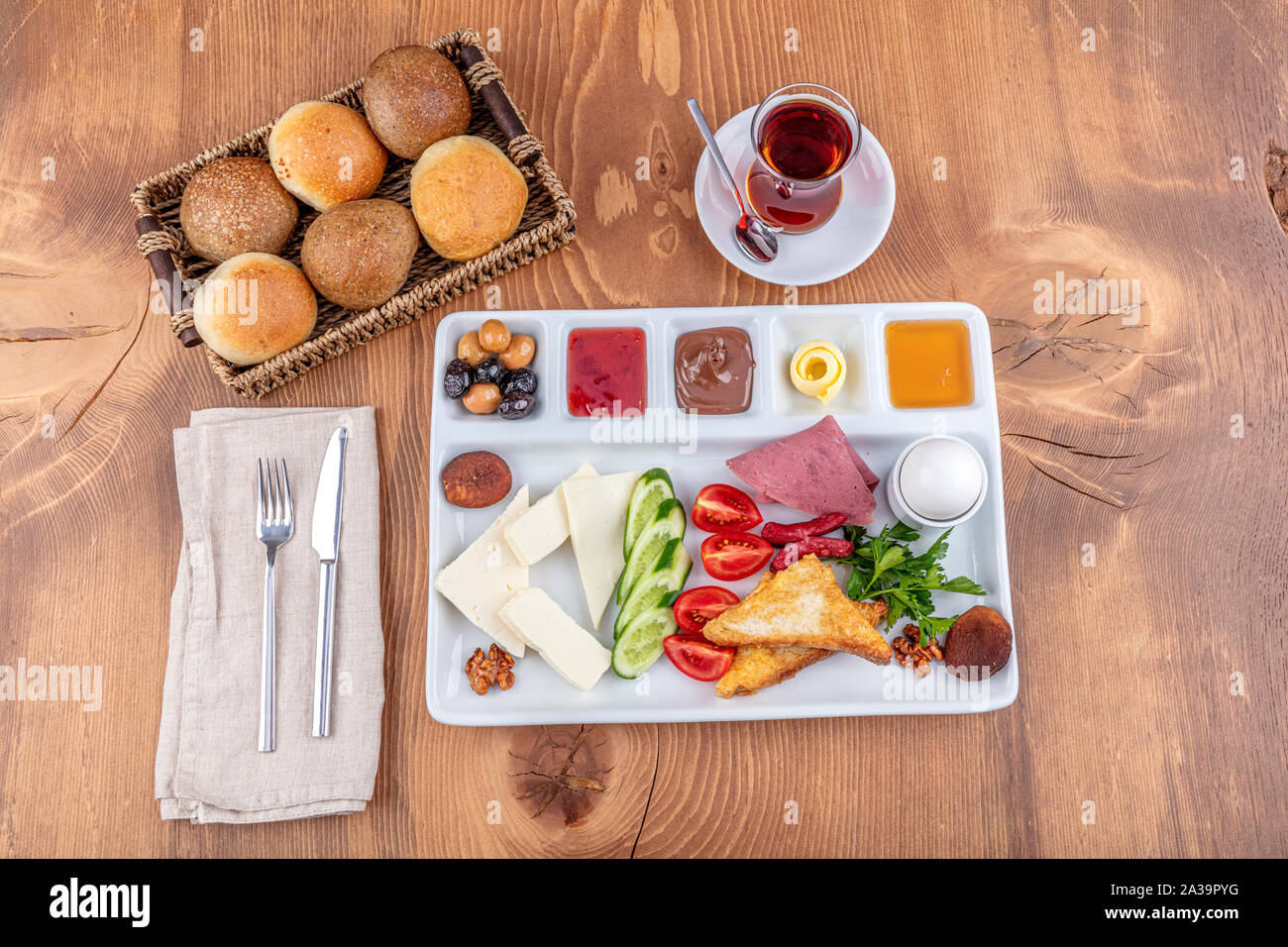 Healthy Turkish style breakfast plate on wooden table in restaurant. Stock Photo