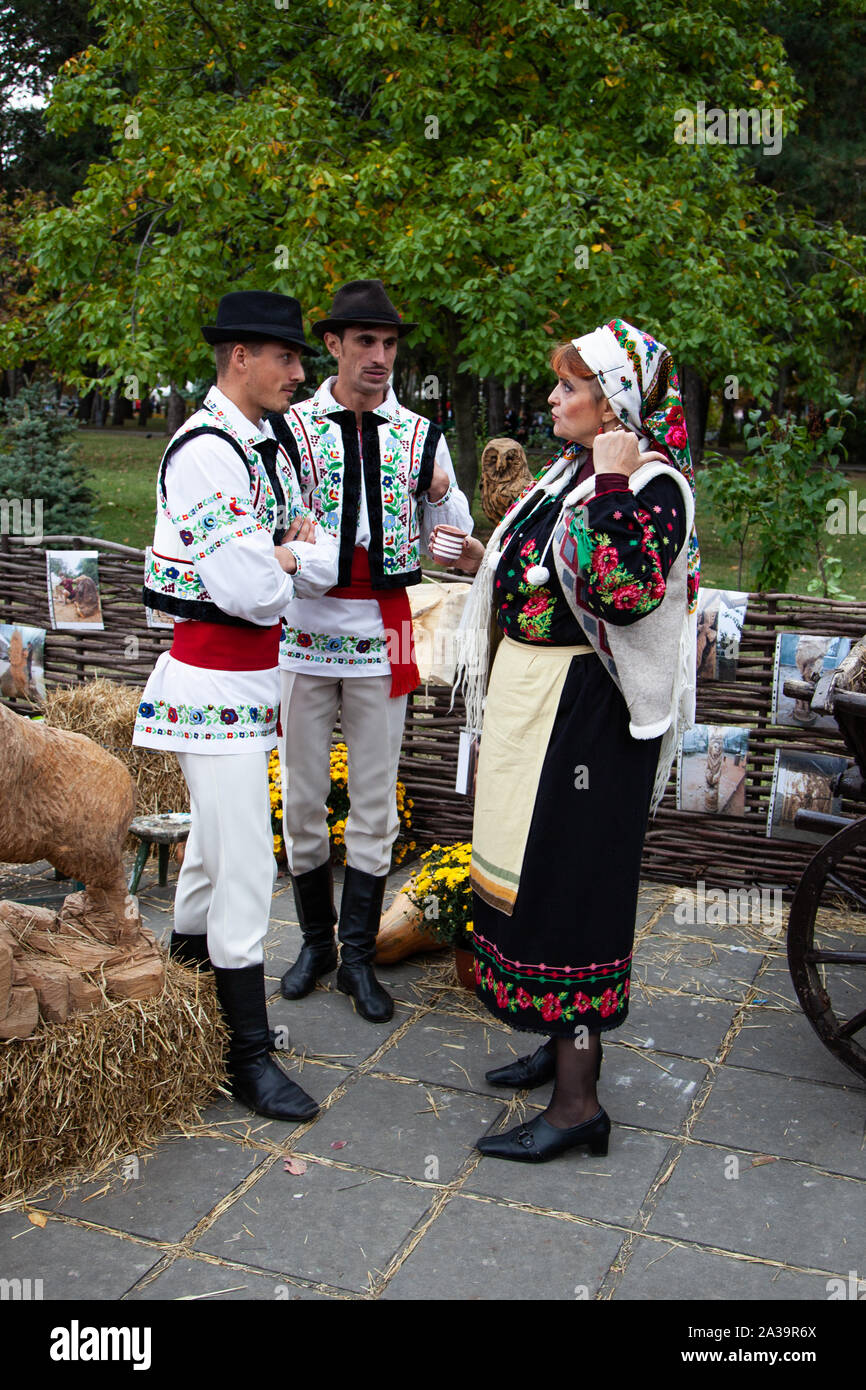 Chisinau, Moldova - October 5, 2019: Young men and woman in traditional Balkanic costumes at a festival in Chisinau, the capital of Moldova. Rest in t Stock Photo