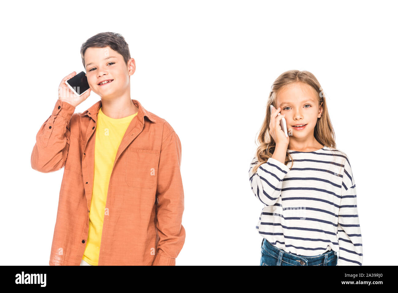 two smiling kids talking on smartphones isolated on white Stock Photo
