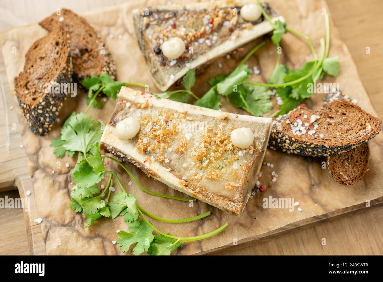 Beef bone marrow with chimichurri sauce and toasted bun. Served on a
