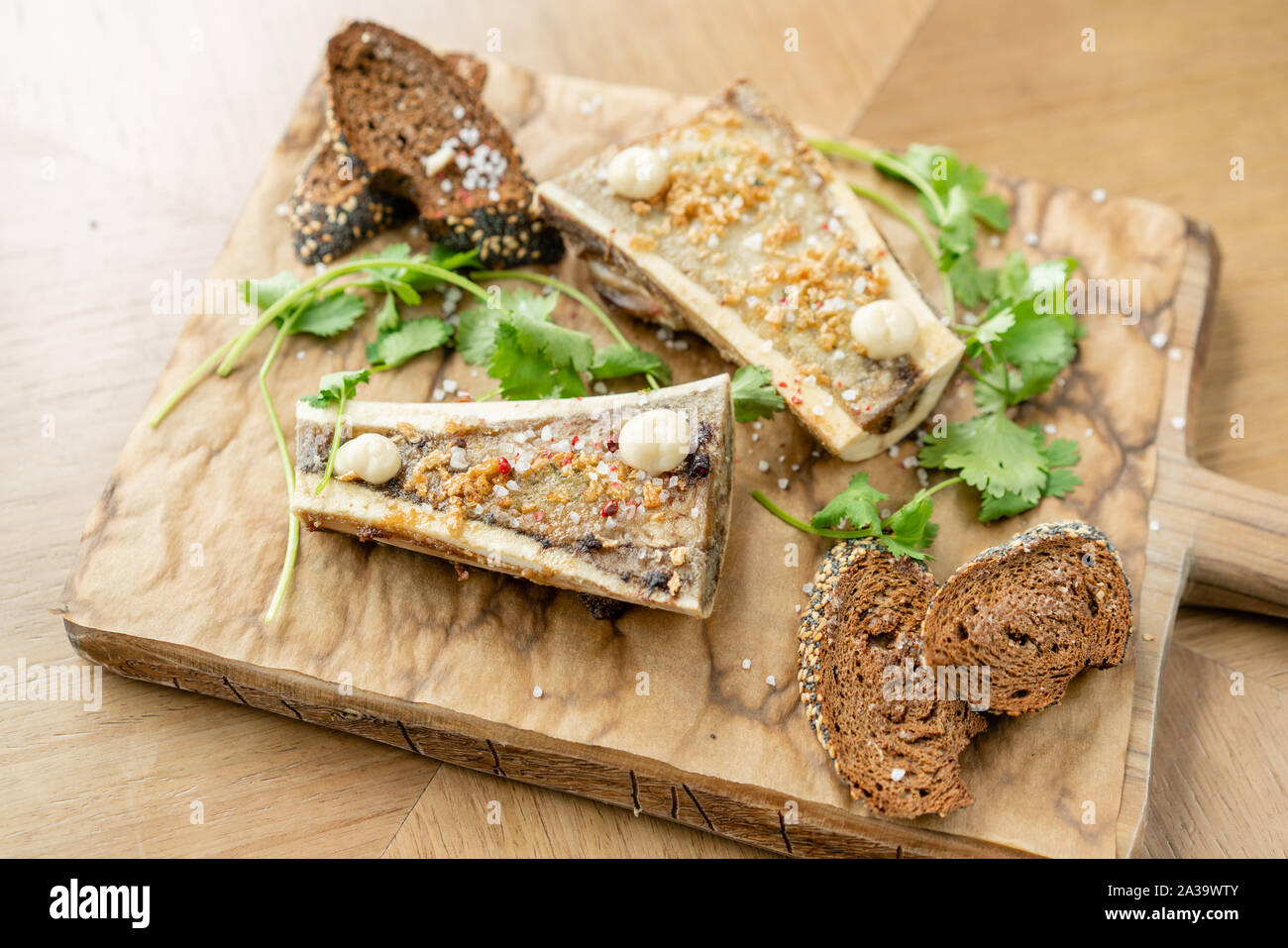 Beef bone marrow with chimichurri sauce and toasted bun. Served on a