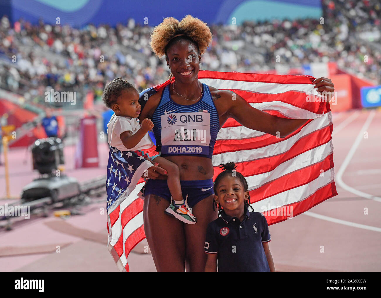 DOHA, QATAR. 06th Oct, 2019. Nia Ali of USA celebrates winning the Gold for Women 100m Hurdles Final with her children during day 10 of the IAAF World Athletics Championships - Doha 2019 at Khalifa International Stadium on Sunday, October 06, 2019 in DOHA, QATAR. Credit: Taka G Wu/Alamy Live News Stock Photo