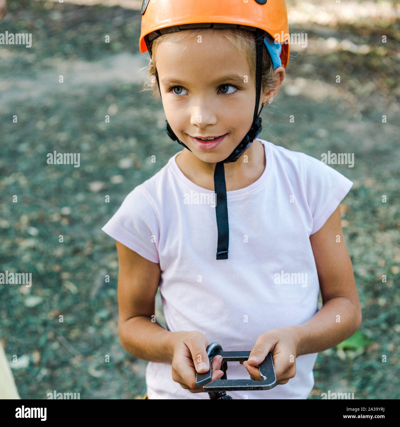 happy kid in helmet holding safety equipment outside Stock Photo Alamy
