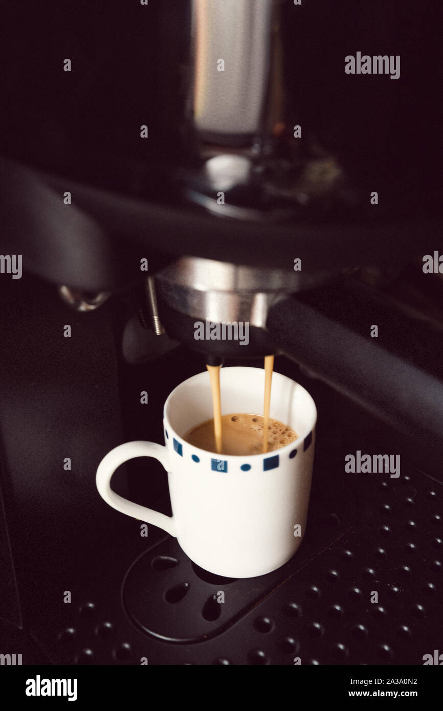 Coffe Cup inside of an Espresso Coffee Machine Stock Photo
