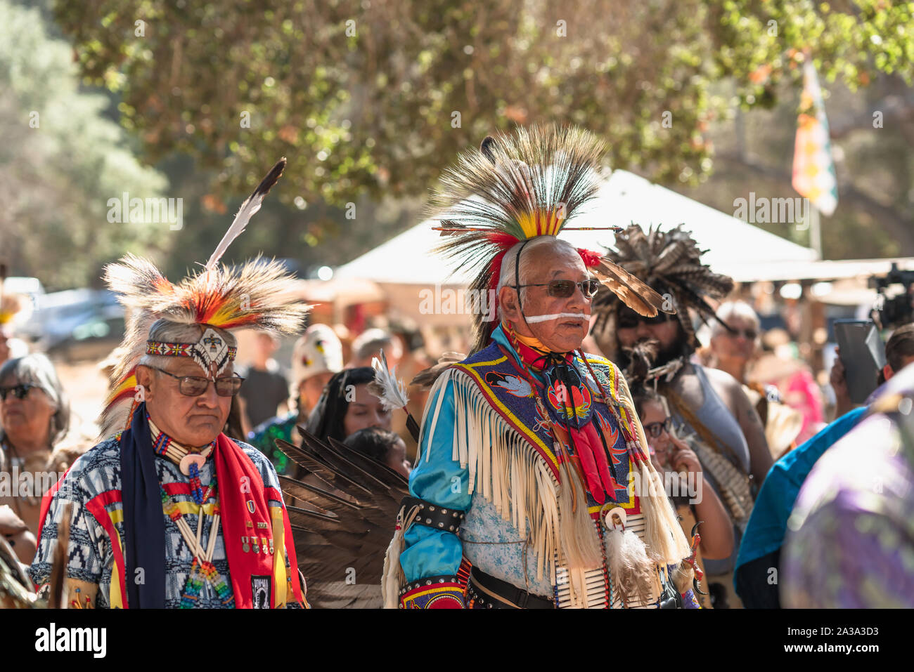 Pow Wow. Grand Entry. Native Americans in full regalia moving in circle