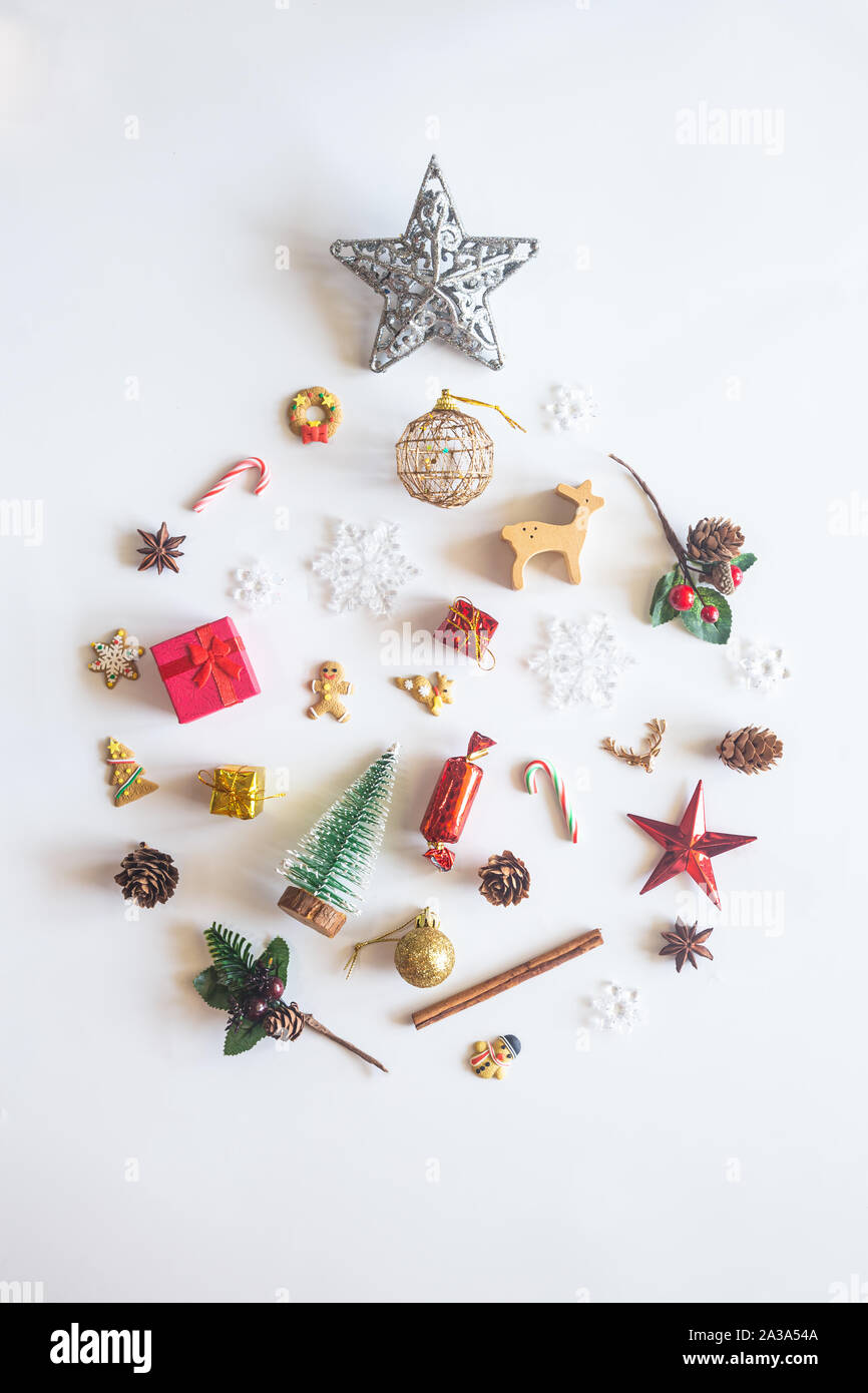 Holiday Christmas card background with festive decoration ball, stars, snowflakes, gift box, pine cones on a white background from Flat lay, top view. Stock Photo