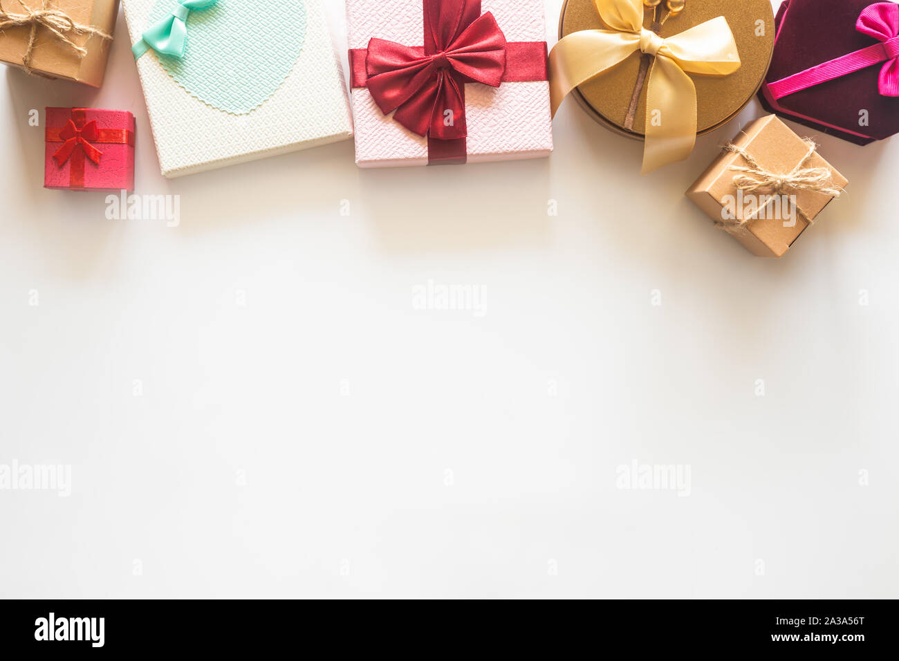 Holiday Christmas card background with festive decoration ball, stars, snowflakes, gift box, pine cones on a white background from Flat lay, top view. Stock Photo