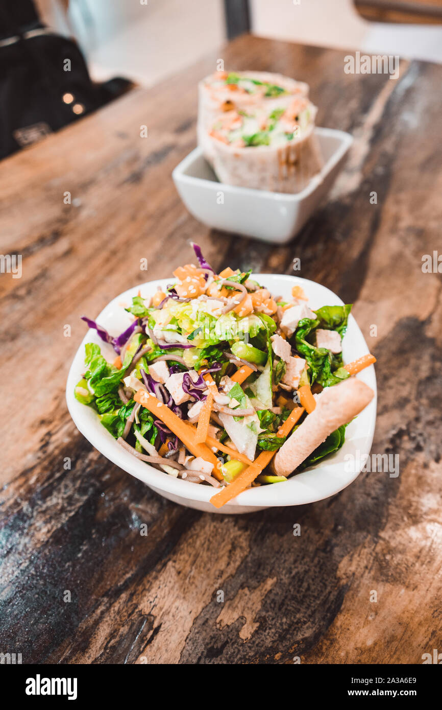 Fresh Salad In A Bowl On A Wooden Table Stock Photo