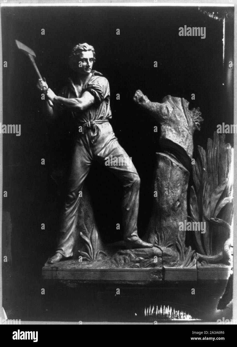 Sculpture of man cutting a tree with an ax Stock Photo - Alamy