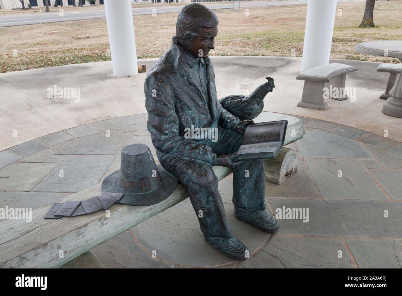 Sculpture of Lonnie Bo Pilgrim, wearing pilgrim dress and reading a