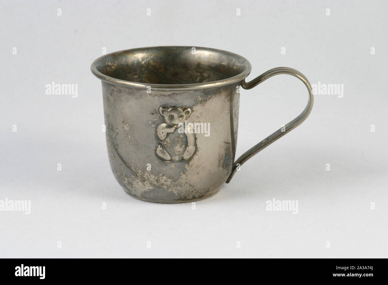 A child's old silver cup. Stock Photo