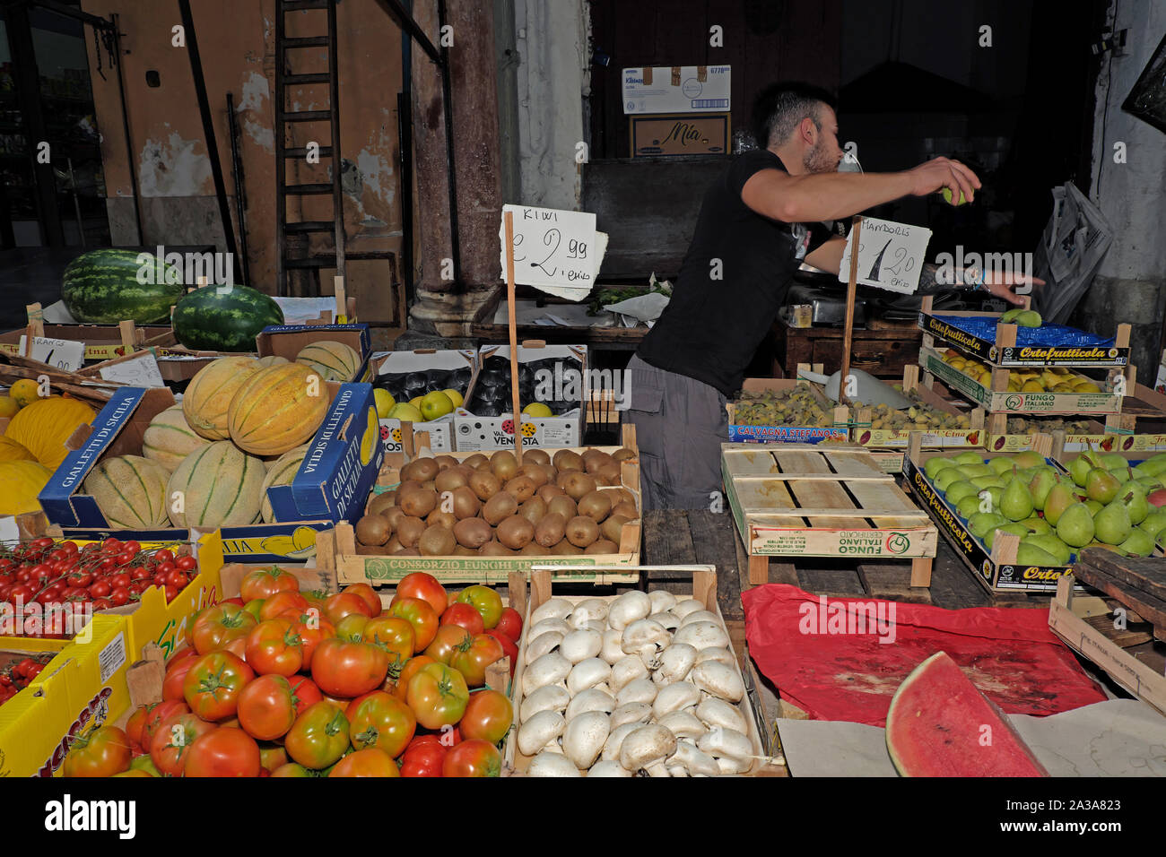 Vendor at produce stand at the outdoor street market of the Mercato di ...