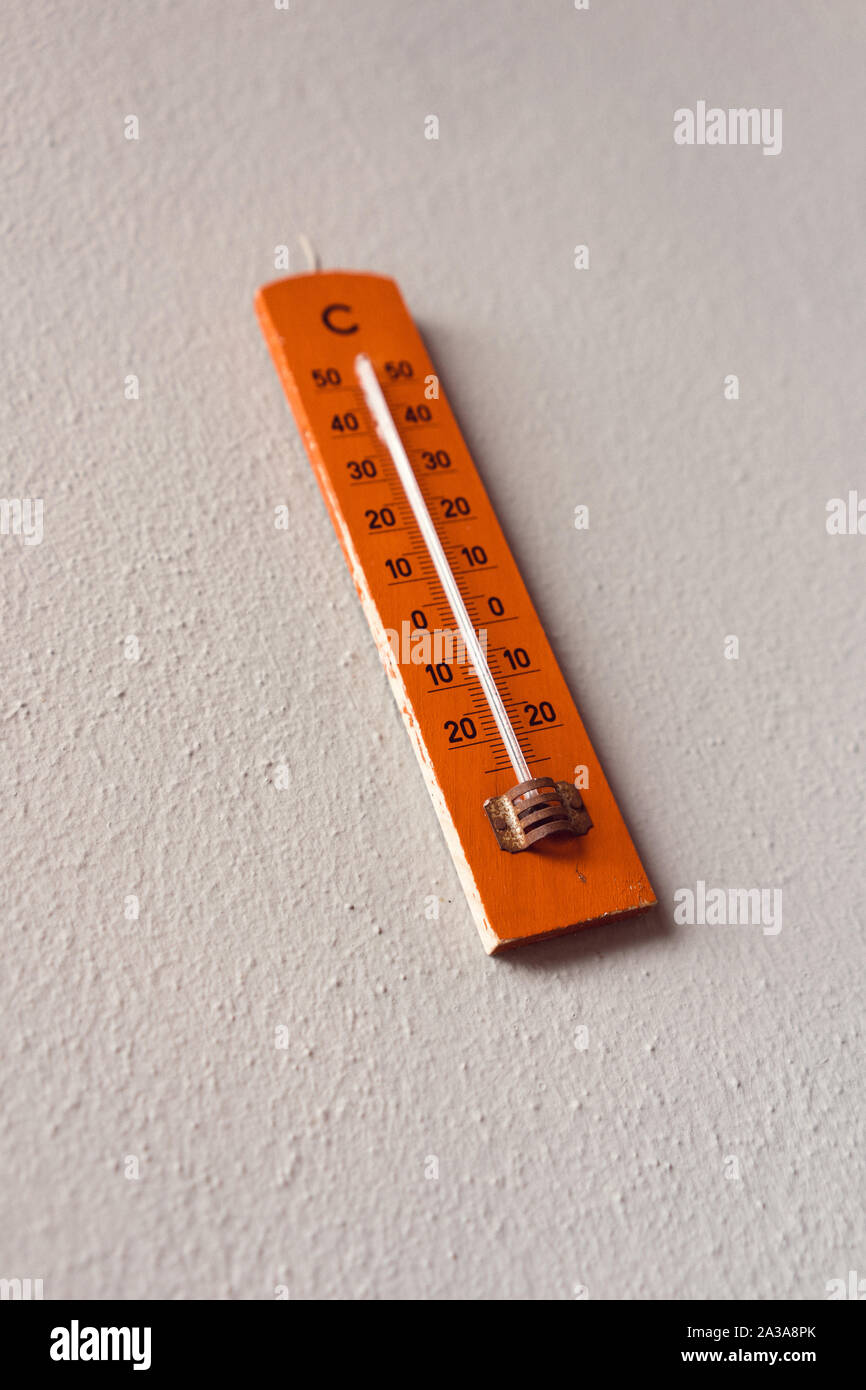Red Termometer hangin on a wall Stock Photo