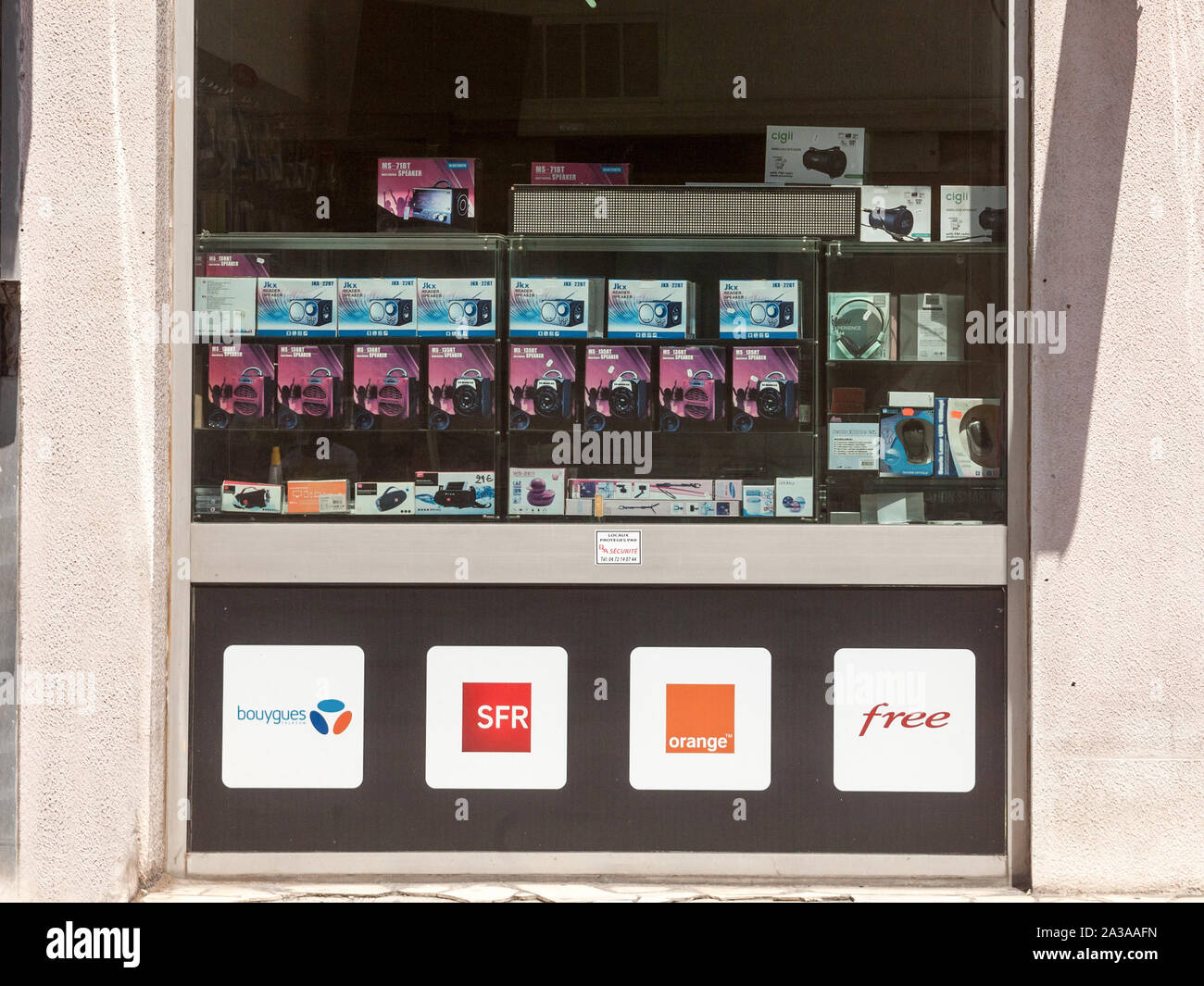 LYON, FRANCE - JULY 15, 2016: Logos of the four telecom operators, competitors & mobile phone carriers of France in front of a telephone shop: Bouygue Stock Photo