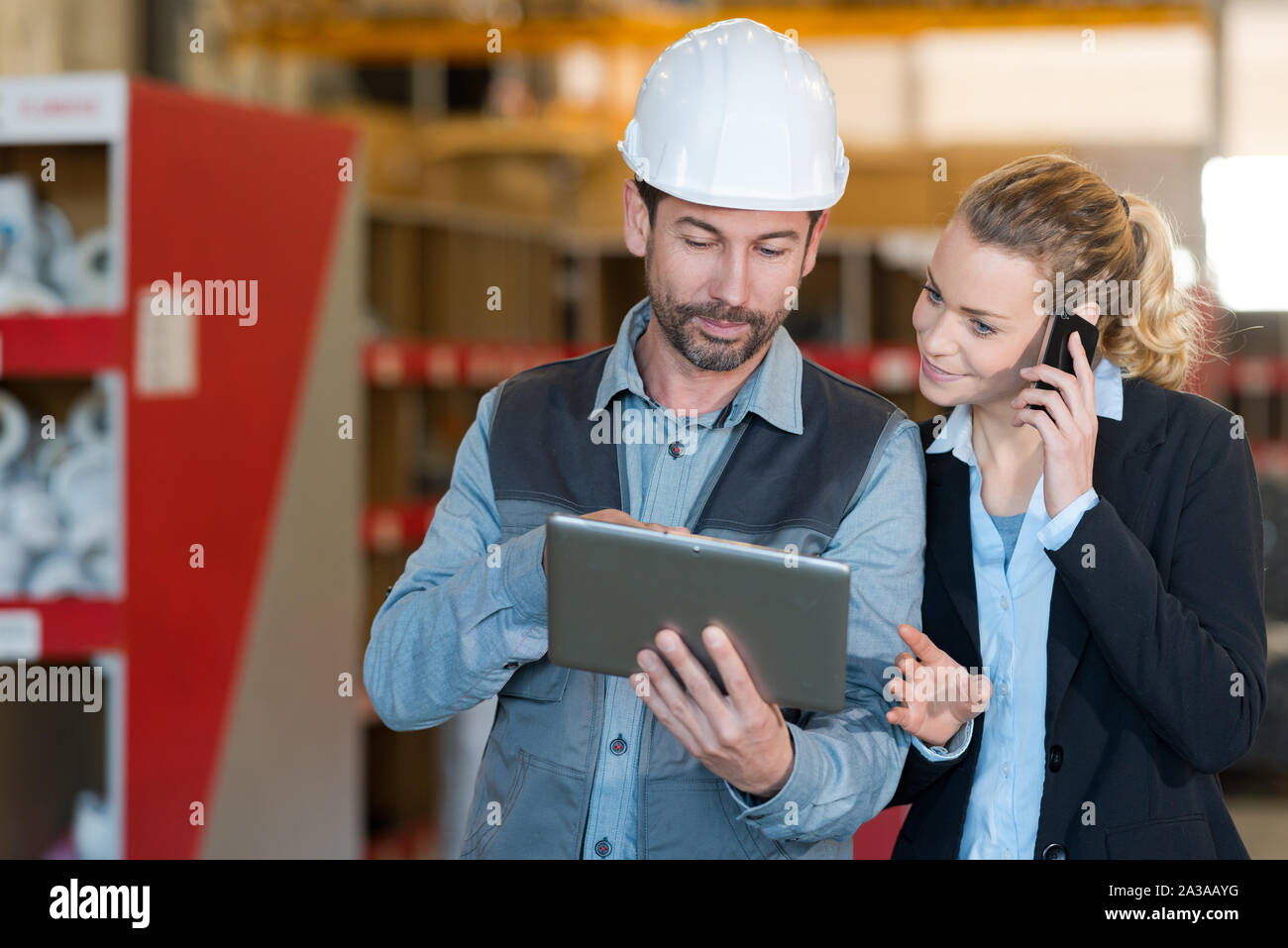 coworkers discussing project by using digital tablet Stock Photo