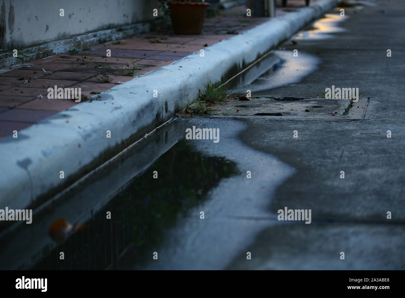 water puddle on the street. poor drainage system left water near catch