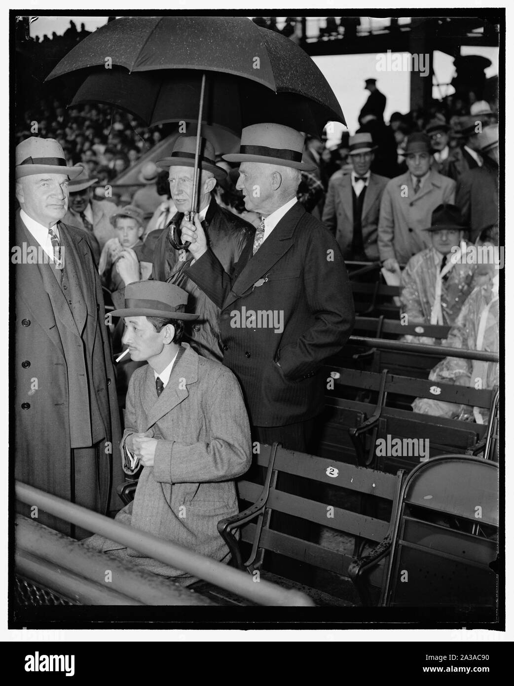 See season's opener. Washington, D.C., April 18. Precedence and politics were off their mind today as the nation's lawmakers, government officials, and diplomats attended today's opening game of the 1938 baseball season between the Washington Senators and the Philadelphia Athletics. Here we see, left to right: J.J. Pelley, President of the Association of American Railroads; Japanese Ambassador Saito, Senator Frederick Hale, of Maine; and William Julian, U.S. Treasurer, 4/18/38 Stock Photo