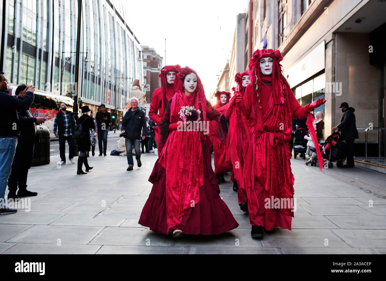 London, UK. 6th October 2019. Extinction Rebellion walk along Oxford Street at the start of two weeks of protests in which they plan to block every single road into central London. Other protest are expected in about 60 cities around the world. Credit: Stuart Boulton/Alamy Stock Photo