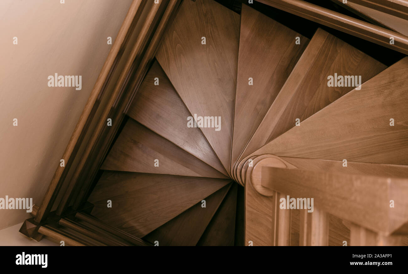 Wooden Spiral Winding Staircase in a house Stock Photo