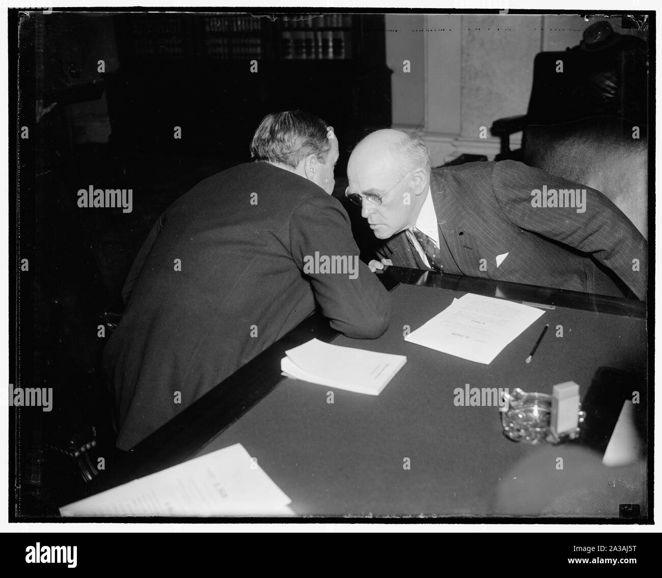 Senatorial huddle. Washington, D.C., Feb. 24. Like Moslems in prayer these two Senators, Robert J. Bulkley of Ohio, and John H. Bankhead, of Alabama, huddled during a lull at Senate Banking and Currency Subcommittee on the Bulkley Bill providing for $6,000,000,000 system of superhighways in the U.S., financed by tolls, 2/24/38 Stock Photo