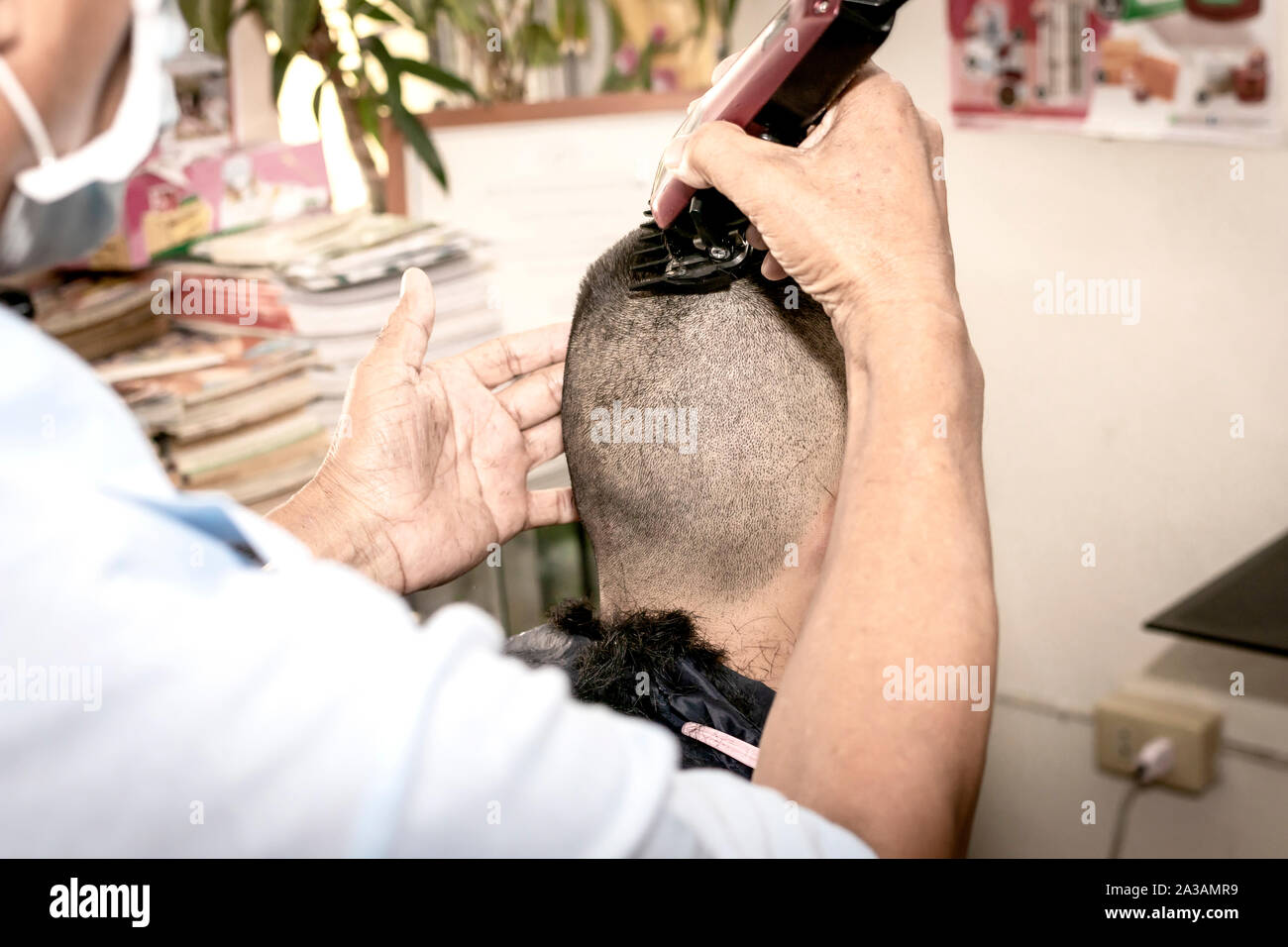 The Crew Cut hairstyle. Short and Easy hair for men. barber making haircut of man in barbershop. Stock Photo