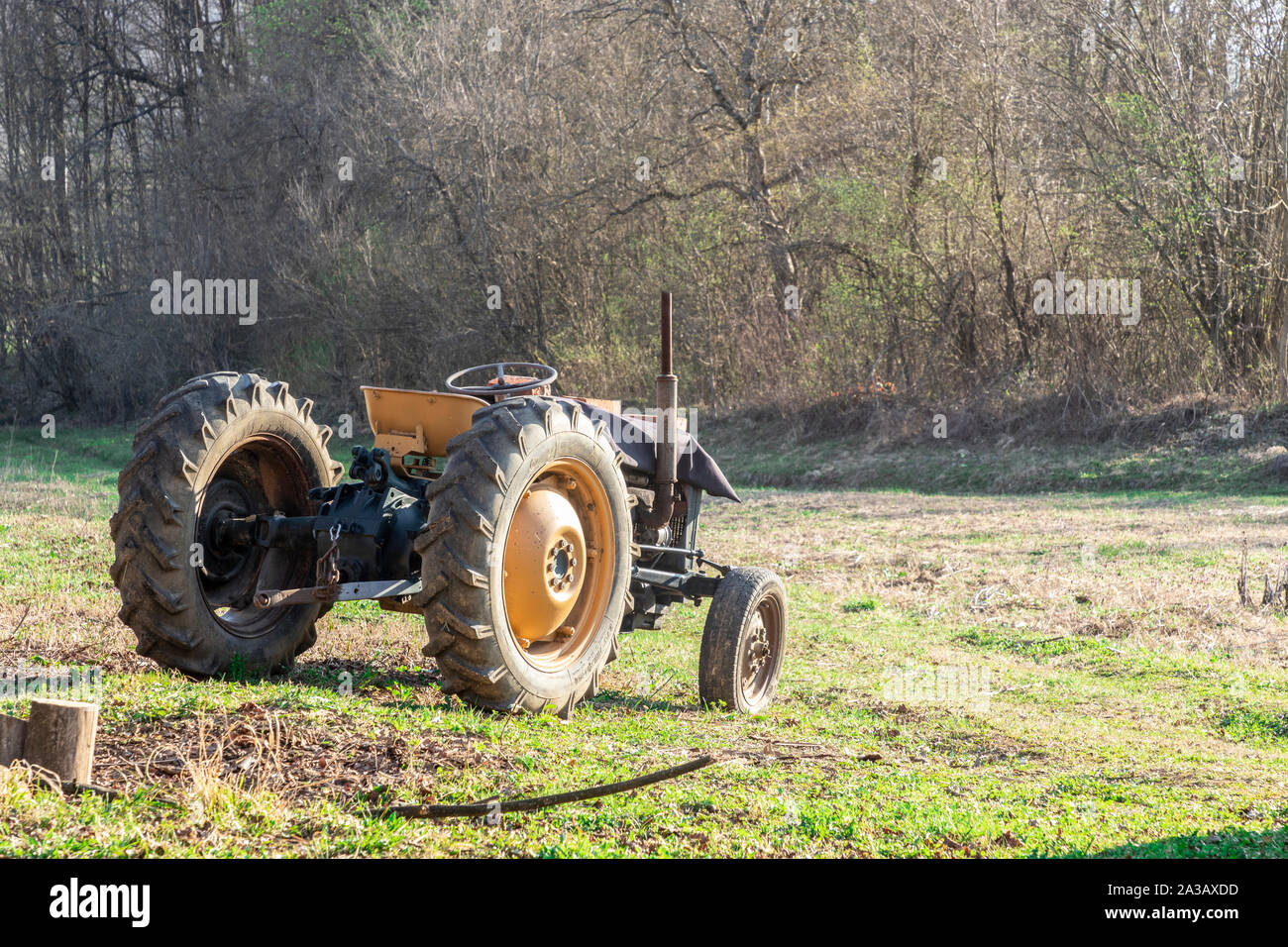 Old tractor in a field in autumn Stock Photo - Alamy