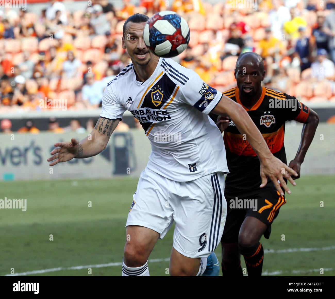 Houston, USA. 6th Oct, 2019. Zlatan Ibrahimovic (L) of LA Galaxy vies with DaMarcus Beasley of Houston during their 2019 Major League Soccer (MLS) match at BMO Field in Houston, the United States, Oct. 6, 2019. Credit: Steven Song/Xinhua/Alamy Live News Stock Photo