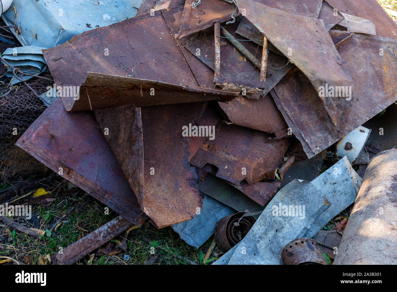 Bits of old rusty scrap metal lying in a heap in a close up full frame view from above Stock Photo