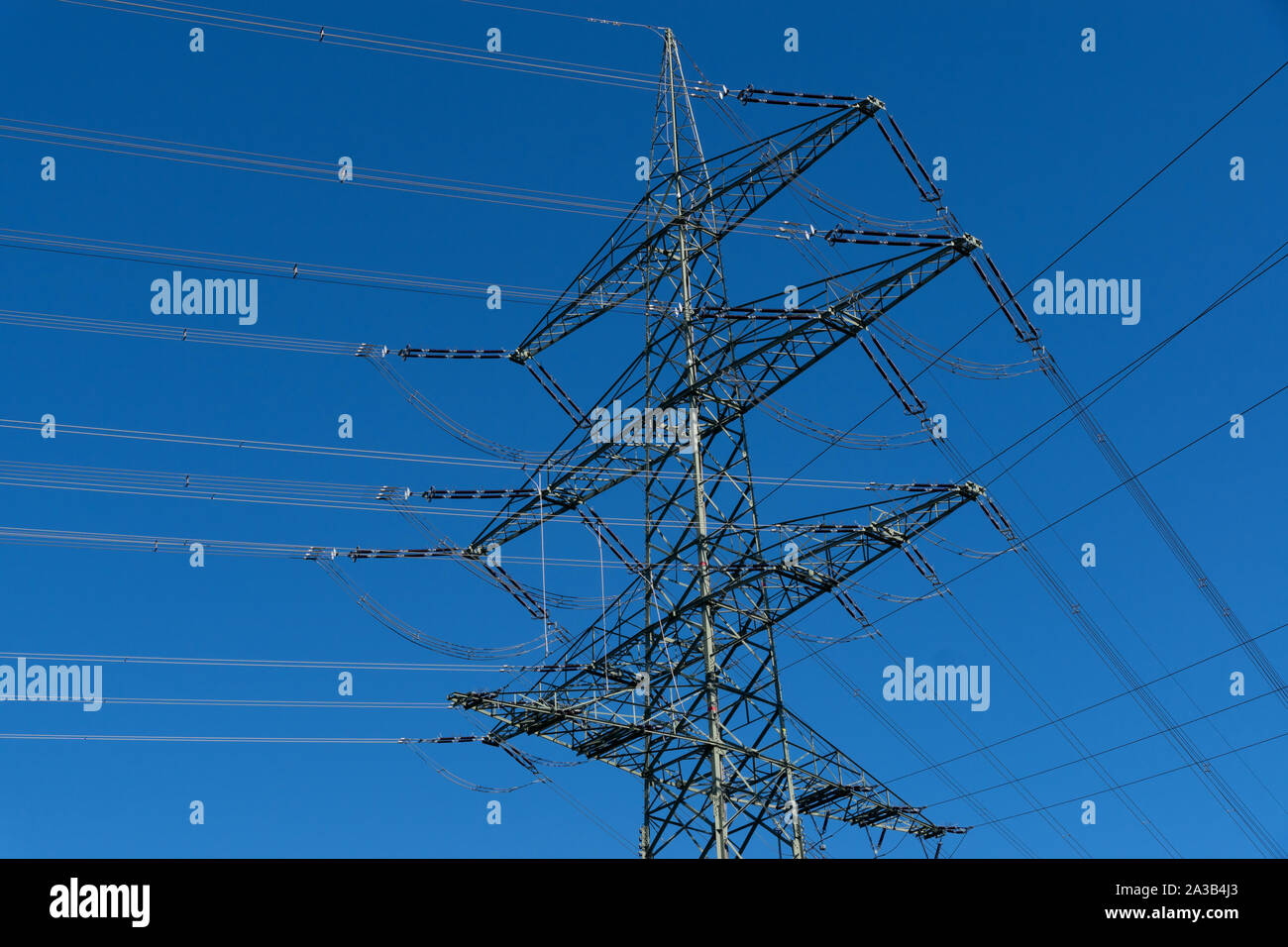 Electricity pylon and blue sky Stock Photo - Alamy