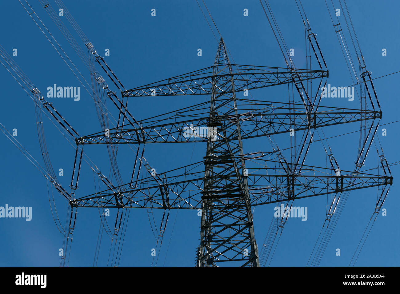 Electricity pylon and blue sky Stock Photo - Alamy
