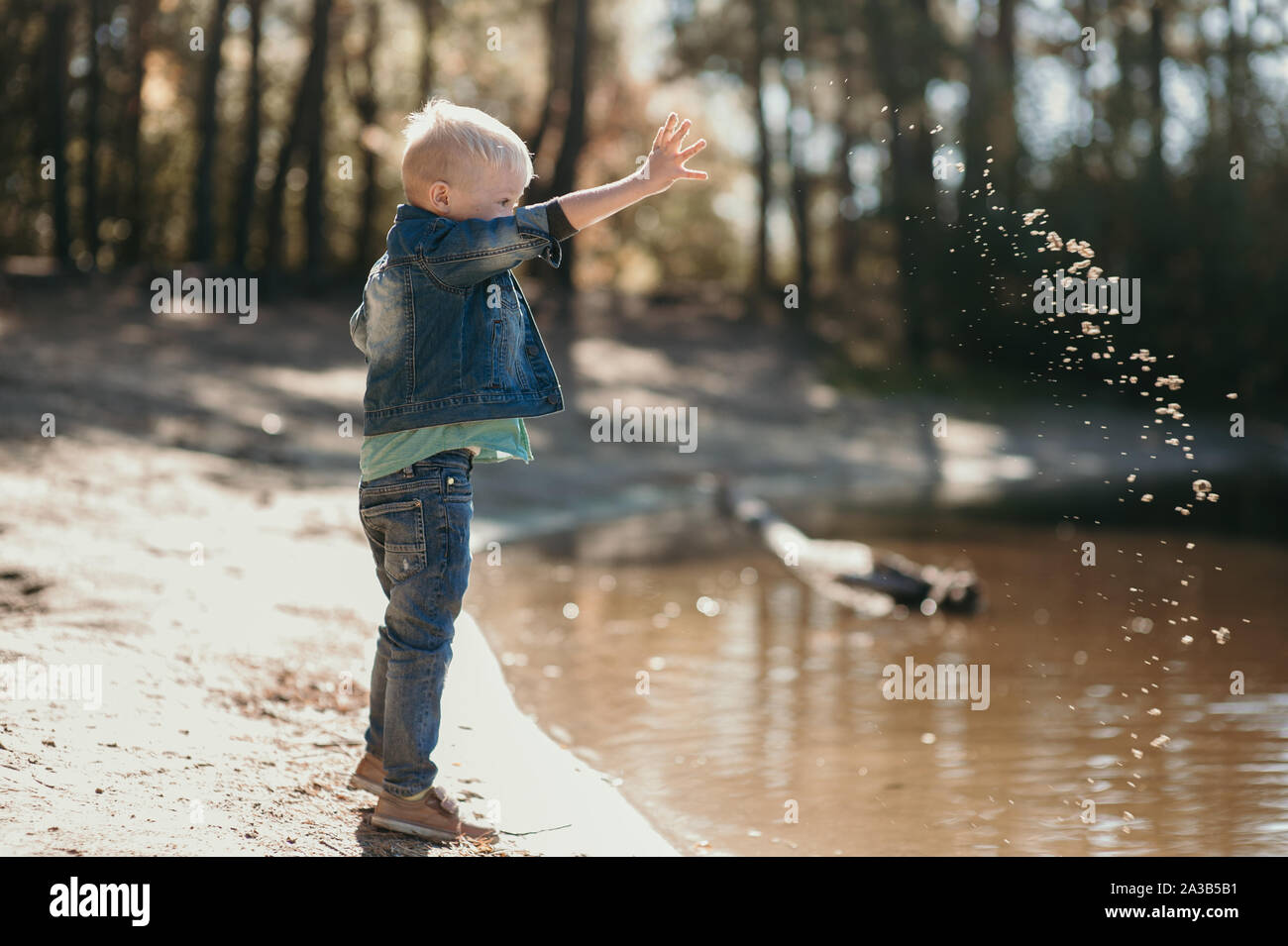 Portrait of cute smiling boy on a summer riverbank. Stock Photo