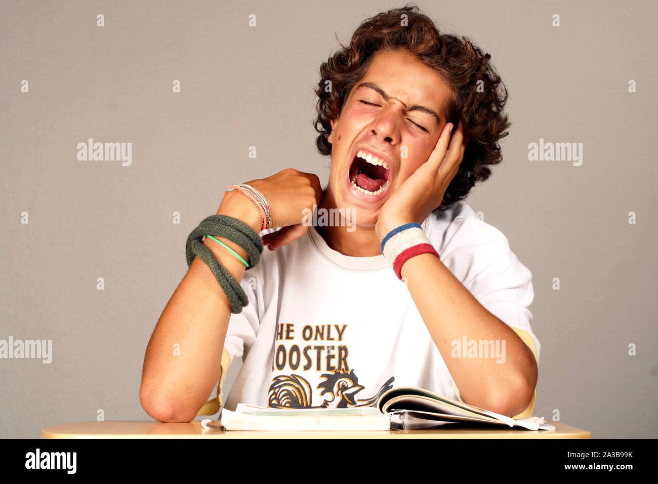 secondary school, teenaged student yawning Stock Photo